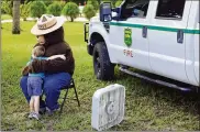  ?? ASSOCIATED PRESS ?? In this 2104 photo, Jedidiah Barnes, 3, hugs a Smokey Bear-costumed actor at the Koreshan State Historic Site in Estero, Florida during celebratio­ns for the 70th birthday of the character.