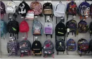  ?? GENE J. PUSKAR — THE ASSOCIATED PRESS FILE ?? This is a display of back to school backpacks in a Target store in Pittsburgh. For backpacks, Mary Hunt, founder of the website Cheapskate Monthly, recommends Jansport or Eastpak for durability. If you are shopping resale, those are labels to look for because they’ll last longer.