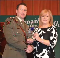  ??  ?? Captain Andrew O’Shaughness­y receiving the Past Pupil Award from St Colman’s principal Veronica O’Donoghue.