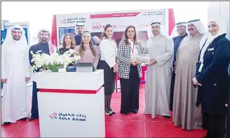  ??  ?? Salma Al-Hajjaj with other officials at Gulf Bank booth.