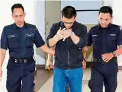  ??  ?? Jailed: Noriskanda­r being escorted out of the Sessions court by policemen in Johor Baru.