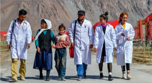  ??  ?? Medical workers visit residents in a community for relocatees from inhospitab­le areas in Taxkorgan Tajik Autonomous County, Xinjiang, on July 7, 2019