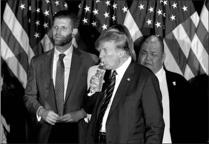  ?? PABLO MARTINEZ MONSIVAIS / ASSOCIATED PRESS ?? Former President Donald Trump takes a drink of water Tuesday night at a primary election party in Nashua, N.H.