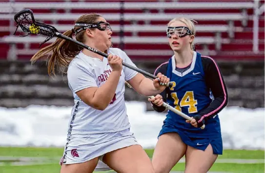  ?? Photos by Jim Franco/times Union ?? Burnt Hills Ballston Lake senior Caroline Kogut takes a shot in front of Averill Park defender Piper Dingee on Friday.