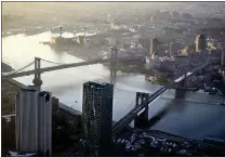  ?? MARK LENNIHAN — ASSOCIATED PRESS, FILE ?? The Manhattan Bridge, left, and the Brooklyn Bridge as seen from One World Trade Center in New York.