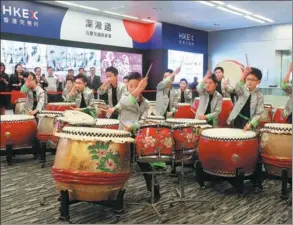  ?? BOBBY YIP / REUTERS ?? Schoolboys perform with Chinese drums as part of a ceremony marking the first day of trade after the Lunar New Year at the Hong Kong stock exchange on Feb 1.