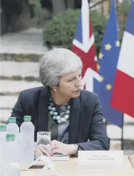  ??  ?? President Emmanuel Macron speaks with Theresa May during