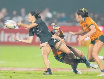  ?? Photo / AP ?? Shiray Kaka of the Black Ferns Sevens gets her pass away in Sharni Williams’ tackle in the Dubai final.
