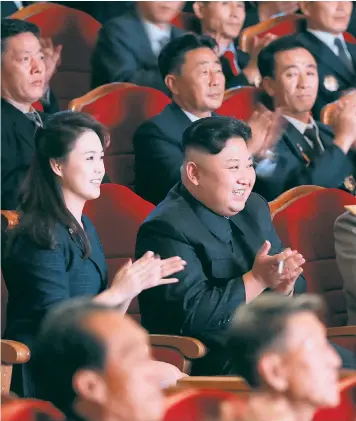  ??  ?? Kim Jong-un, with his wife Ri Sol-ju in a rare public appearance, applauds scientists who contribute­d to a hydrogen bomb test