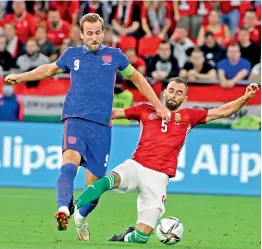  ?? —
AP ?? England’s Harry Kane (left) vies for the ball with Hungary’s Attila Fiola during their Fifa World Cup 2022 qualifying match at the Puskas Ferenc Arena in Budapest on Thursday. England won 4-0.