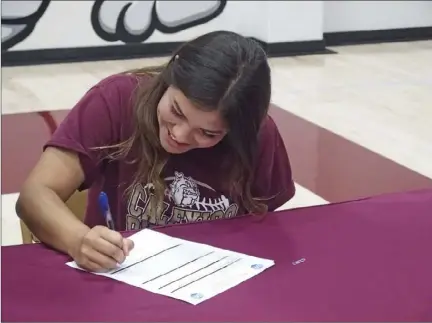  ??  ?? Calexico High senior Danielle Burgos signs her letter of intent to play softball at Arizona Western College during a signing ceremony last week. KARINA LOPEZ PHOTO