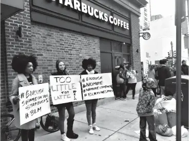  ?? Associated Press ?? ■ Protesters gather outside a Starbucks on Sunday in Philadelph­ia where two black men were arrested Thursday after Starbucks employees called police to say the men were trespassin­g. The arrest prompted accusation­s of racism on social media. Starbucks...