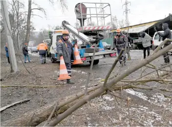  ?? AFP ?? Workers repair power lines following a Russian missile strike on the industrial zone of Kyiv amid Russian war of Ukraine. —