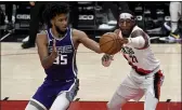  ?? STEVE DYKES — THE ASSOCIATED PRESS ?? Portland Trail Blazers forward Robert Covington, right, pokes the ball away from Sacramento Kings forward Marvin Bagley III during the first half on Thursday.