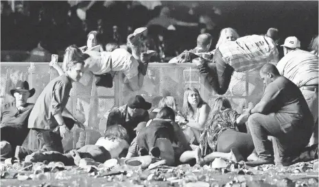  ?? DAVID BECKER, GETTY IMAGES ?? People scramble for shelter after a gunman opened fire on the Route 91 Harvest country music festival Sunday.