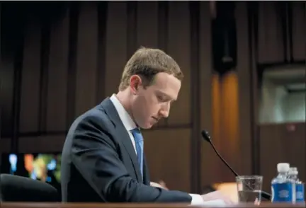  ?? ANDREW HARNIK — THE ASSOCIATED PRESS FILE ?? Facebook CEO Mark Zuckerberg pauses while testifying before a joint hearing of the Commerce and Judiciary Committees on Capitol Hill in Washington about the use of Facebook data to target American voters in the 2016 election. The British Parliament has released some 250 pages worth of documents that show Facebook considered charging developers for data access. The documents show internal discussion­s about linking data to revenue.