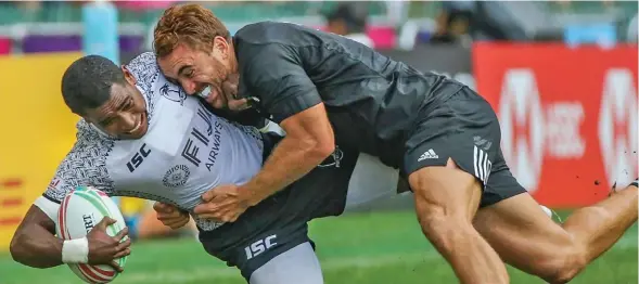  ?? Photo: SCMP ?? Fiji Airways Fijian 7s winger Aminiasi Tuimaba is tackled by Joe Webber of New Zealand during last year’s Hong Kong 7s. Over the years Fiji and NZ are rivals during the World Sevens Series.