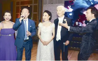  ??  ?? Soprano Rachelle Gerodias, Eritrea consul Dr. George Yang and tenor Byeong-In Park serenade the lovely couple Nonie and Bert Basilio