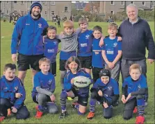  ??  ?? Campbeltow­n Junior Rugby Club coach Chris Doxsey, back left, has paid tribute to founder John Forster, back right, who died last month. The coaches and players are seen here at the Mid Argyll Dalriada in November 2019.