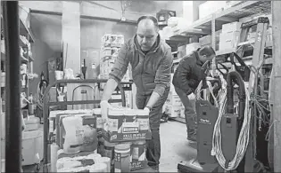  ?? JOHN J. KIM/CHICAGO TRIBUNE ?? Goodman Theatre facilities manager Frank Leyden, left, and production manager Scott Conn move boxes of disinfecta­nt wipes to a central storage area March 21 in Chicago.