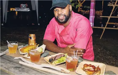  ??  ?? Chef Shea Stewart of Elite Kreations chills with his grilled masterpiec­es, alongside their perfectly paired intoxicati­ng mixes.