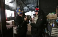  ??  ?? In this Friday photo, American freestyle skier Gus Kenworthy (left) and his boyfriend Matthew Wilkas hold dogs at a dog meat farm in Siheung, South Korea. Kenworthy saved five stray dogs during the Sochi Olympics four years ago and is considerin­g...