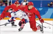  ?? CHANGW. LEE / THE NEWYORK TIMES ?? U.S. forward Ryan Donato (16) is checked by Russian defenseman ArtyomZub during theirGroup B preliminar­y round fifinale on Saturday.