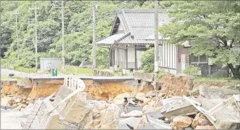  ??  ?? Photo shows a collapsed road due to heavy rain in Higashihir­oshima, Hiroshima prefecture. — AFP photo