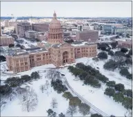 ?? Jay Janner / TNS ?? The Texas Capitol grounds are covered in snow on Feb. 15 in Austin, Texas. Registered voters say state and local leaders failed to adequately alert the public about the deadly punch the recent Texas storm could deliver.