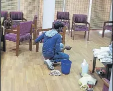  ?? HT PHOTO ?? A worker polishing furniture in room number 19 on the seventh floor of the secretaria­t.