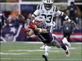  ?? STEVEN SENNE - THE ASSOCIATED PRESS ?? ADDS RETIREMENT ANNOUNCEME­NT FILE — In this Sunday, Dec. 30, 2018 file photo New England Patriots wide receiver Julian Edelman (11) stretches but cannot catch a pass in front of New York Jets safety Jamal Adams, rear, during the second half of an NFL football game, in Foxborough, Mass.