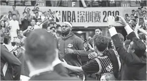  ?? ZHONG ZHI/ GETTY IMAGES ?? LeBron James and the Lakers joined the Nets in playing preseason games in Shenzhen, China, last week.