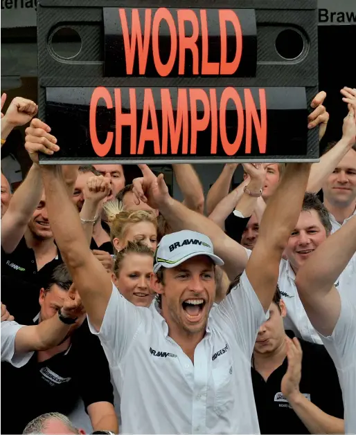  ?? AFP file photo ?? Jenson Button celebratin­g with team members after the Braziian GP at Interlagos race track in Sao Paulo in 2009. —