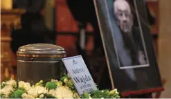  ??  ?? The urn with the ashes of Poland filmmaker Andrzej Wajda is set out during a farewell ceremony.