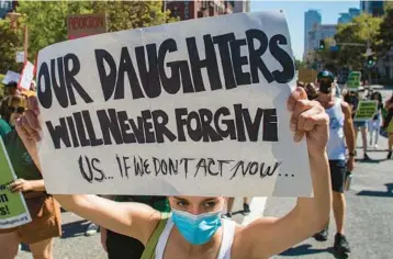  ?? APU GOMES/GETTY-AFP ?? A marcher holds a sign Sunday while taking part in an abortion-rights protest in downtown Los Angeles.