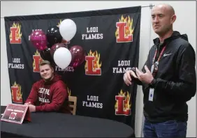  ?? MIKE BUSH/NEWS-SENTINEL ?? Above: Lodi High Athletic Director Robert Winterhalt­er (right) talks before Kent Powell inks his National Letter of Intent with Central Washington University inside the school's library on Wednesday. Below: Mason Ginni signs his agreement to attend Westmont College inside the Liberty Ranch High library.