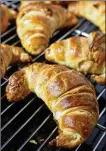  ?? ?? Baked croissants cooling on a wire rack on Oct. 20.