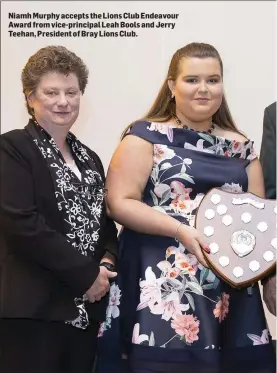  ??  ?? Niamh Murphy accepts the Lions Club Endeavour Award from vice-principal Leah Bools and Jerry Teehan, President of Bray Lions Club.