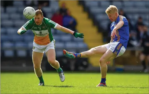  ??  ?? Wicklow’s Mark Kenny gets his shot away as Offaly’s Niall Darby closes in.