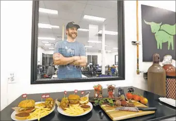  ?? Genaro Molina Los Angeles Times ?? ETHAN BROWN, founder and chief executive of Beyond Meat, looks over some of its meat-replacemen­t products, including the Beyond Burger 2.0, at the company’s headquarte­rs in El Segundo.