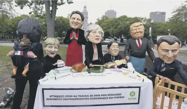  ?? PICTURE: AFP/GETTY IMAGES ?? 0 Members of Oxfam dressed as the ‘G7 leaders’ pose for pictures outside the Quebec provincial building ahead of the G7 summit in Quebec City