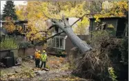  ?? MARK BLINC/ REUTERS ?? In the Toronto area, falling trees damaged some houses, debris killed a woman and many were without power.