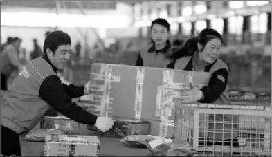  ?? ZHU XINGXIN/CHINA DAILY ?? The expressmen with Shentong Express are sorting the mails in Beijing. Increasing sellers have participat­ed in the Singles’ Day festival and an estimated 400 million parcels will be delivered during the festival, a record 50 percent increase over last...