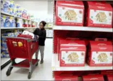  ?? JULIO CORTEZ — THE ASSOCIATED PRESS ?? A shopper looks at an item before placing it in her cart during a trip to a Target store in Edison, N.J.