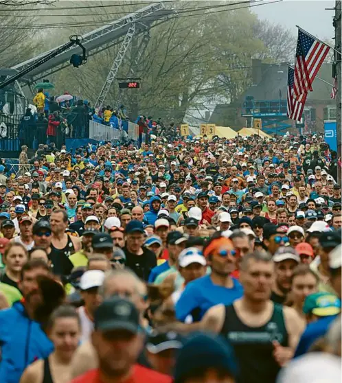  ?? DAVID L RYAN GLOBE STAFF ?? Among the faces in the Marathon crowd were David Krejci’s wife, Naomi, and Justin Turner’s wife, Kourtney.