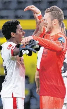  ?? FOTO: GUIDO KIRCHNER/DPA ?? Kaum zu glauben: Die Mainzer Leandro Barreiro Martins (li.) und Torwart Florian Müller feiern den Sieg in Dortmund.