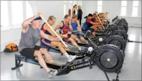  ?? MICHILEA PATTERSON — DIGITAL FIRST MEDIA ?? Members of the Philadelph­ia Dragon Boat Associatio­n use the new paddling erg room of the Pottstown Athletic Club for the first time. The room is open to area dragon boat teams as a training opportunit­y in the winter.