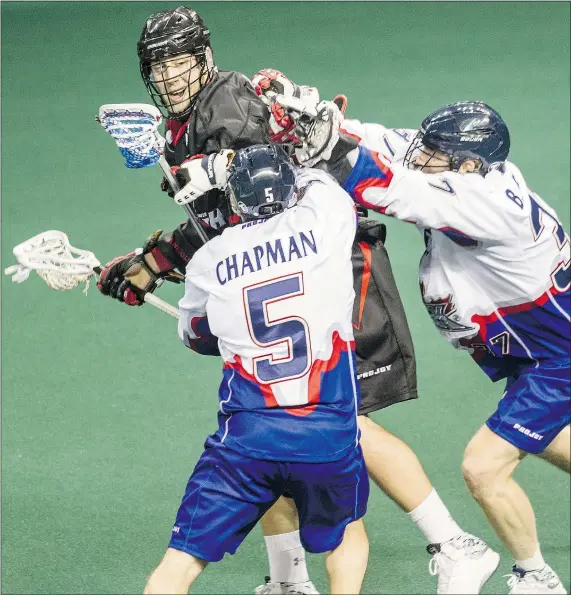  ??  ?? The Stealth’s Tyler Digby battles Toronto Rock players during his team’s NLL home-opener in Langley on Saturday night.