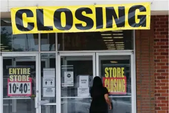  ?? Associated Press ?? ■ A woman walks into a closing Gordmans store on Thursday in St. Charles, Mo. Stage Stores, which owns Gordmans, is closing all its stores and has filed for Chapter 11 bankruptcy.