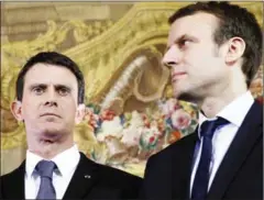  ?? PATRICK KOVARIK/AFP ?? Then-French Prime Minister Manuel Valls (left) and then-French Economy and Industry Minister Emmanuel Macron meet for a press conference in France last year.